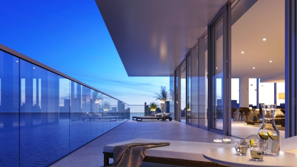 Modern balcony overlooking ocean at sunset