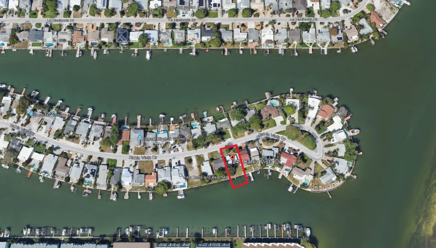 Aerial view of a waterfront neighborhood with houses, boats, and a canal with a red outline highlighting a specific property at 344 Bahia Vista Drive